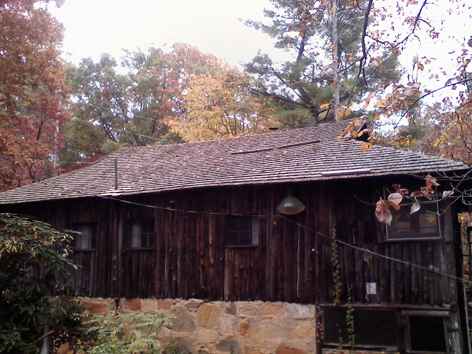 Weathered wood shake roof on a rustic board sided cabin in Copperas Cove